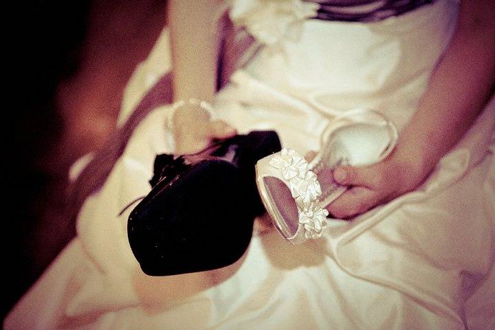 Bride Holding Her and Her Grooms Shoe